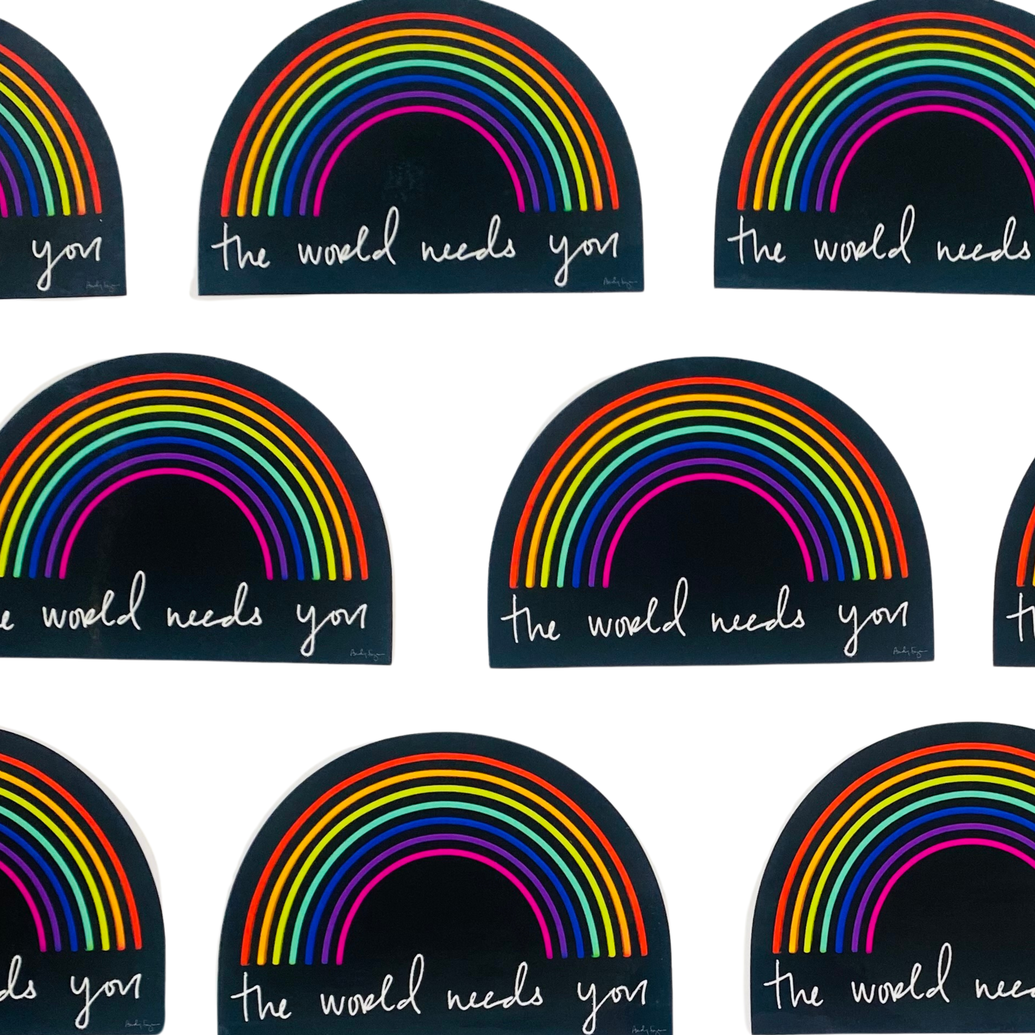 Stickers with rainbow design and text 'the world needs you' on a white background