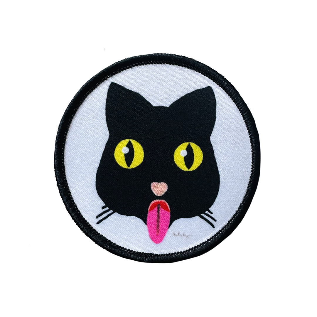 Puss Patch by Fryed Candy - Circular patch with a black cat face design on a white background