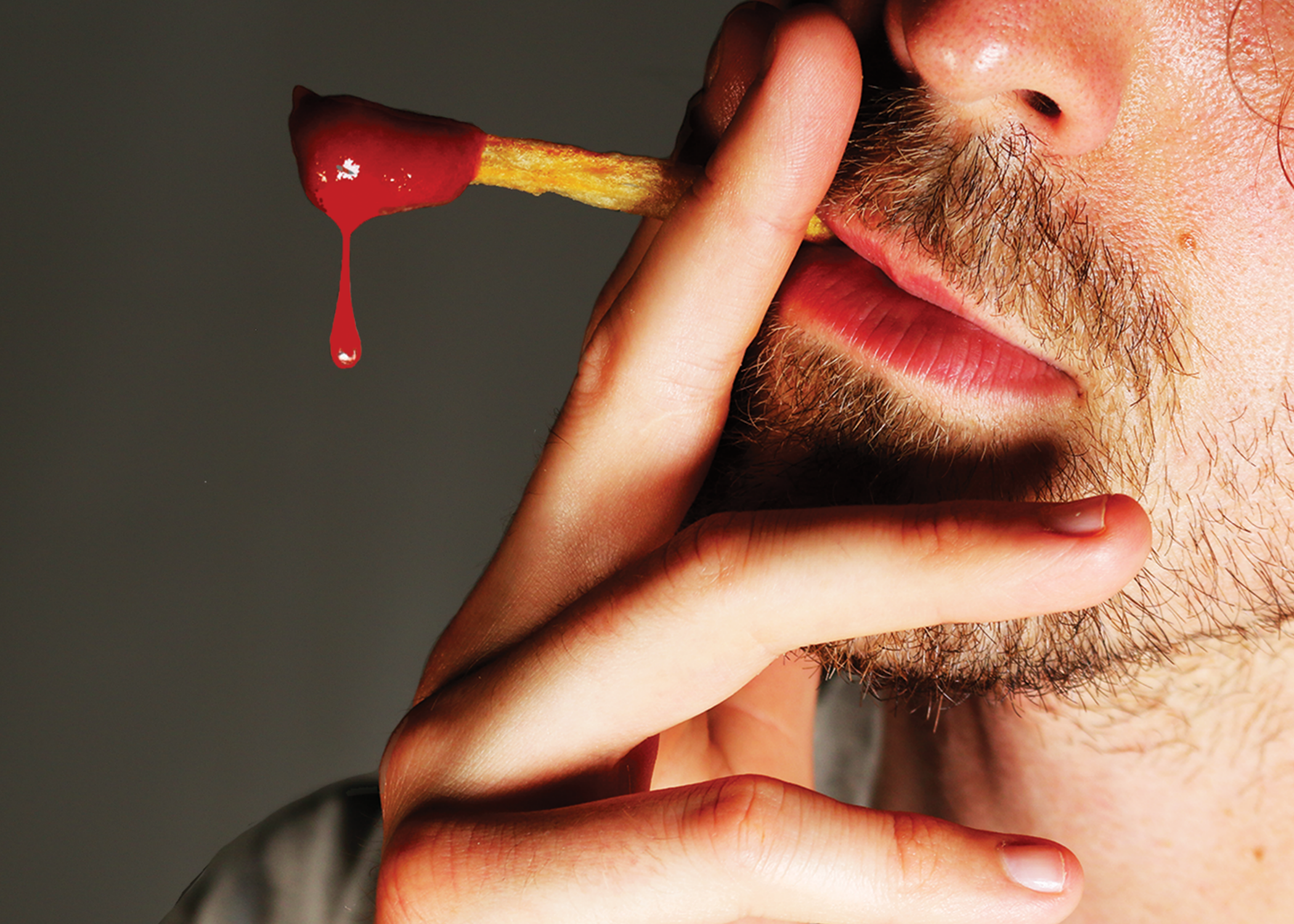 Smoking Fry by Fryed Candy - Man holding a blood-stained toothpick to his nose against a dark background